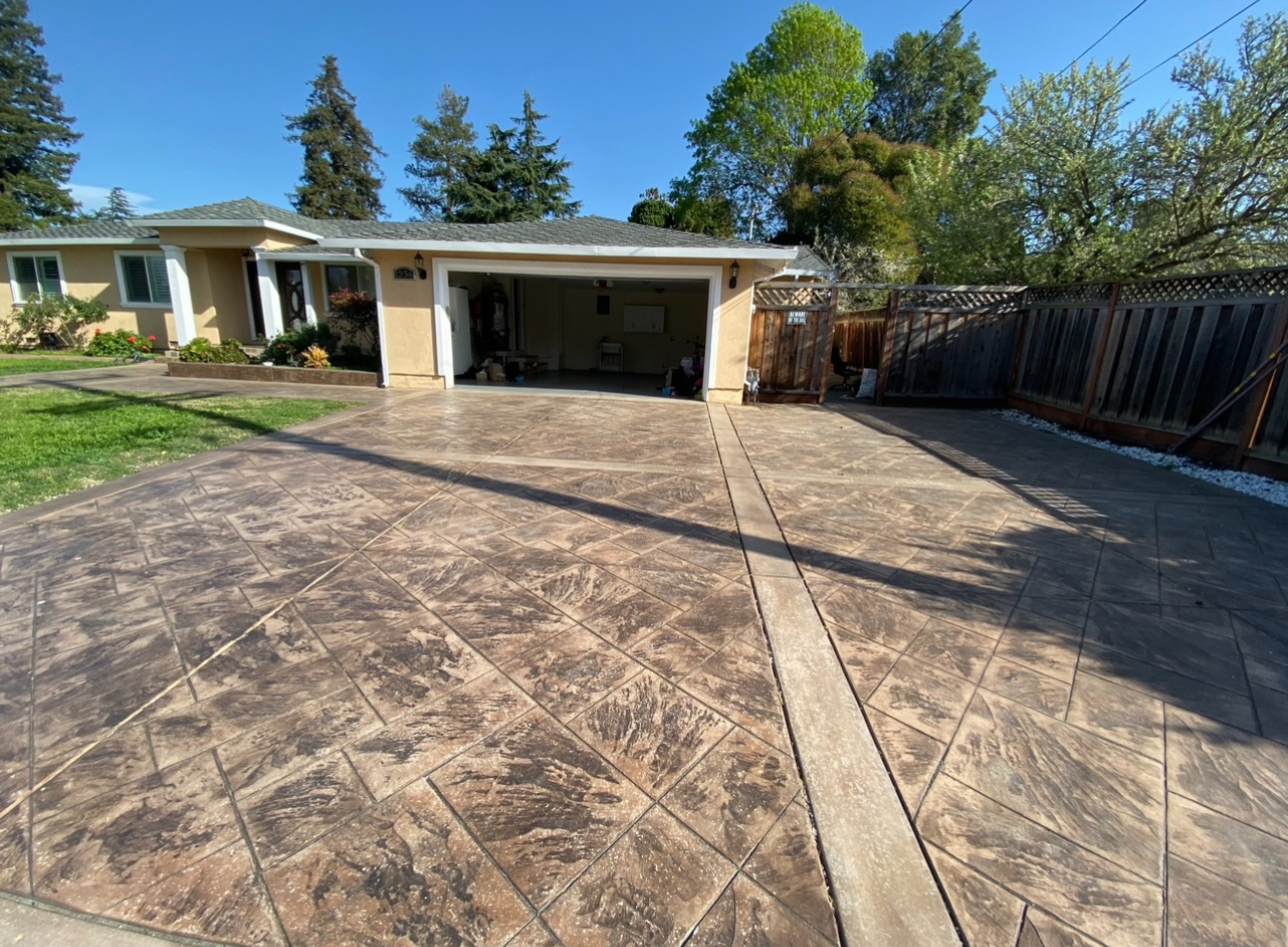 Stamped concrete driveway with tile pattern in warm tones