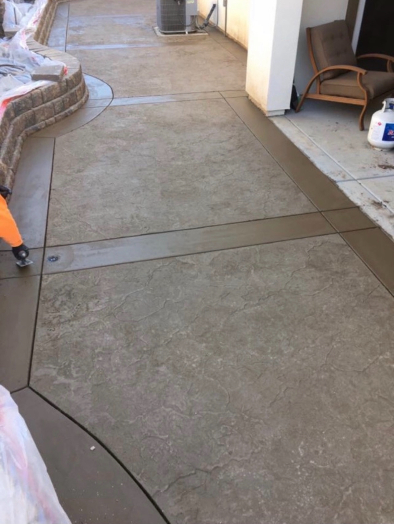Stamped concrete patio with stone texture and bordered bands