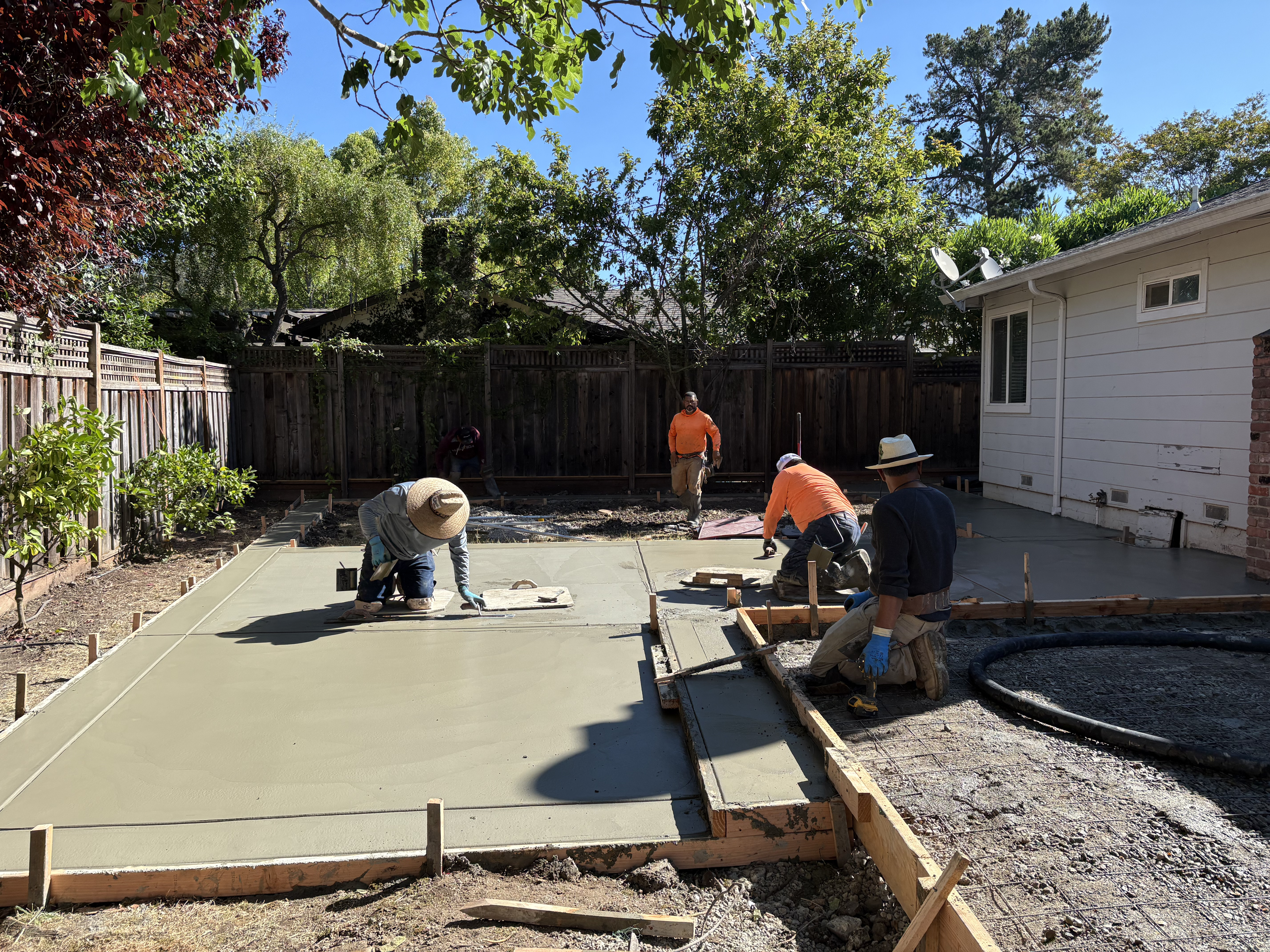 Skygrid Hardscaping crew installing natural stone pavers