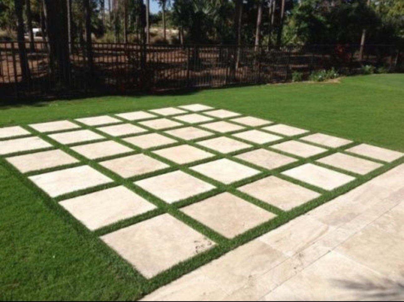 Artificial turf with paver inlay grid pattern