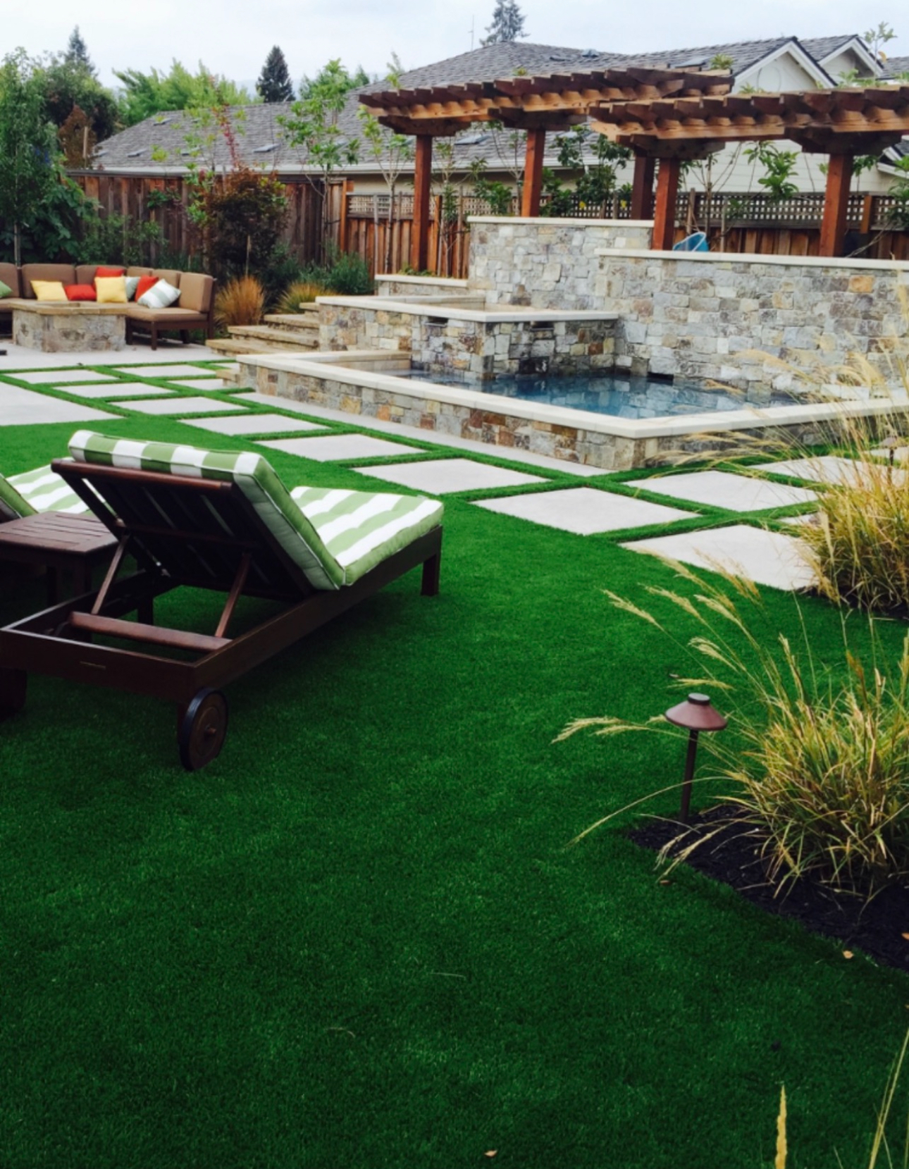 Backyard turf with paver walkway and pool deck
