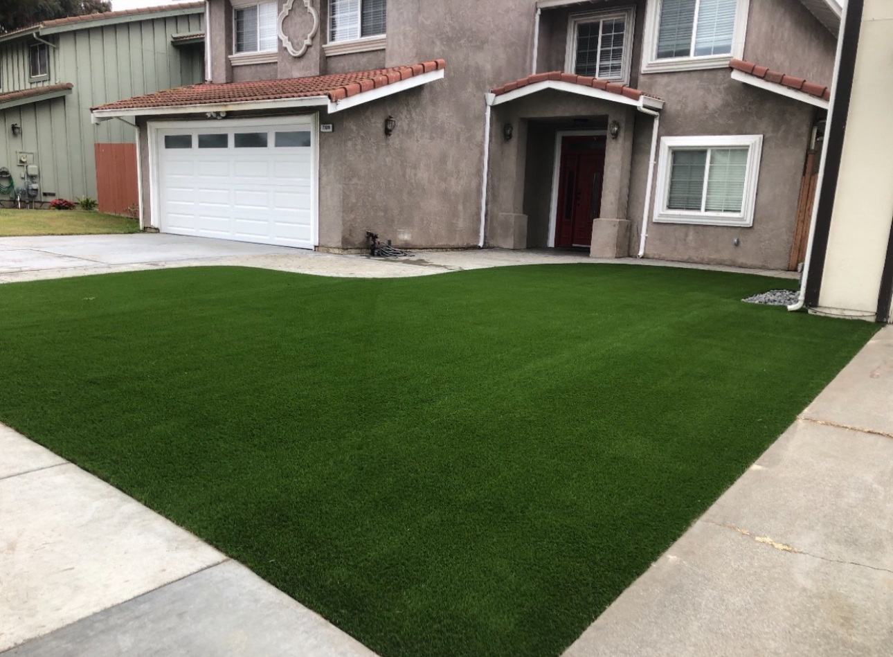Front yard artificial turf with clean concrete borders